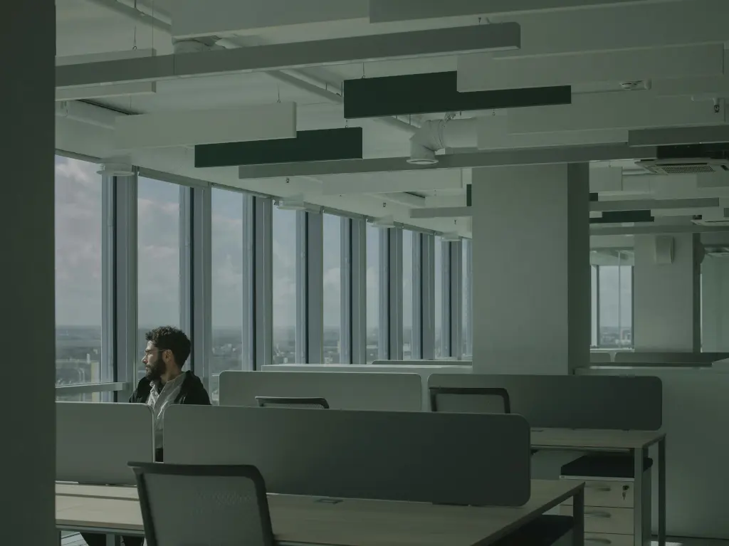 Illustration illustrating the bad reputation of the company. In the photo, a lonely man in an empty, gray office.